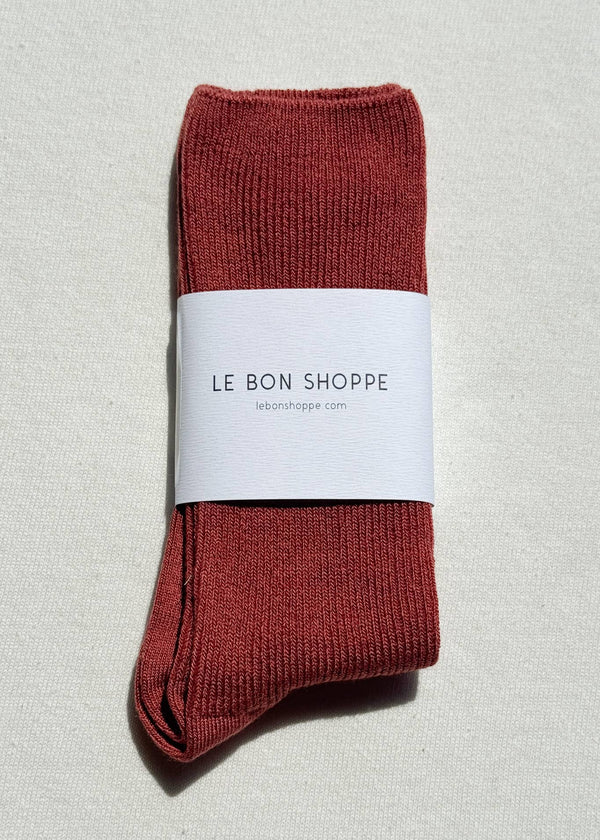 Red socks with a white label on a light gray background