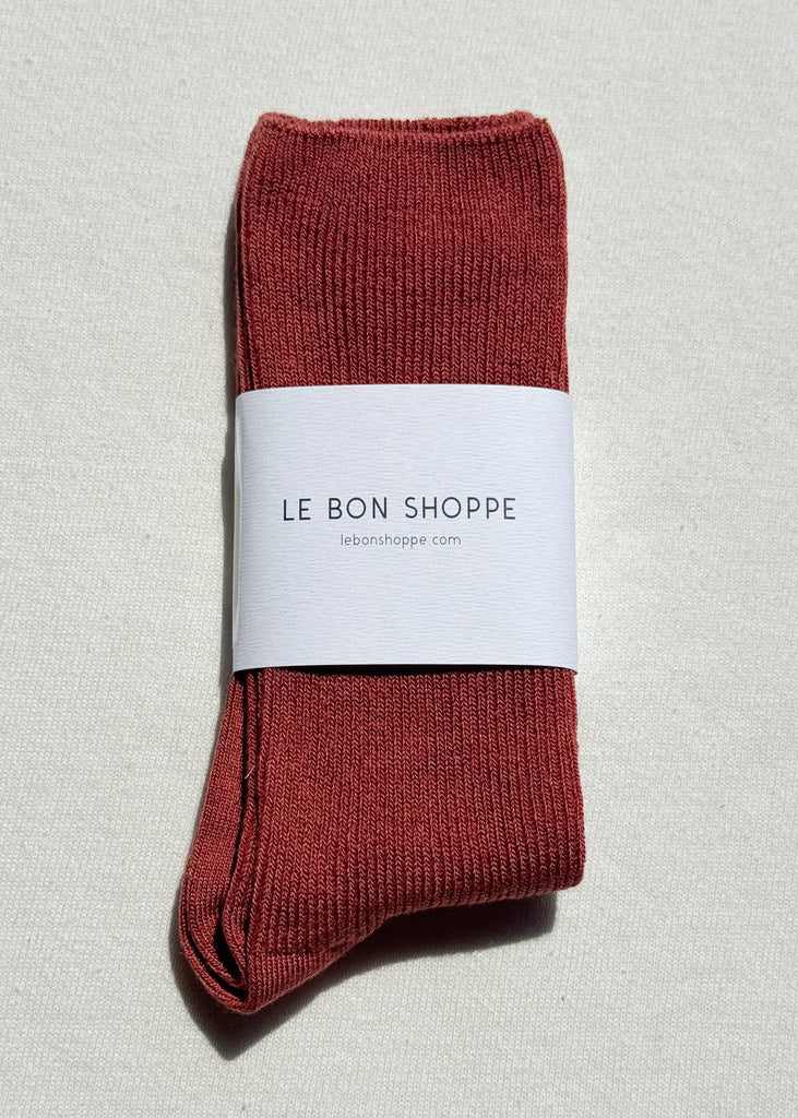 Red socks with a white label on a light gray background