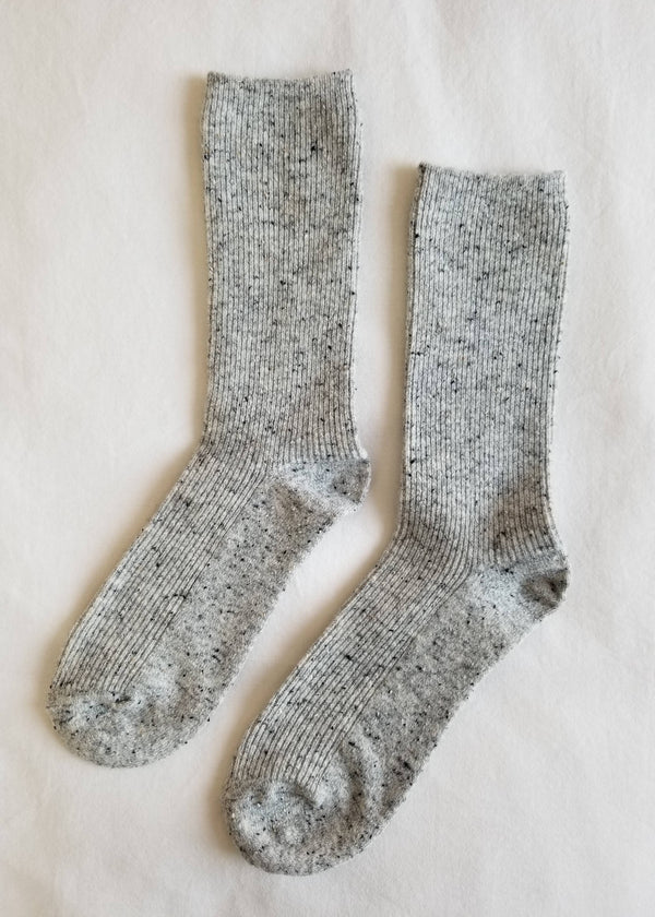 Pair of gray socks on a light beige background
