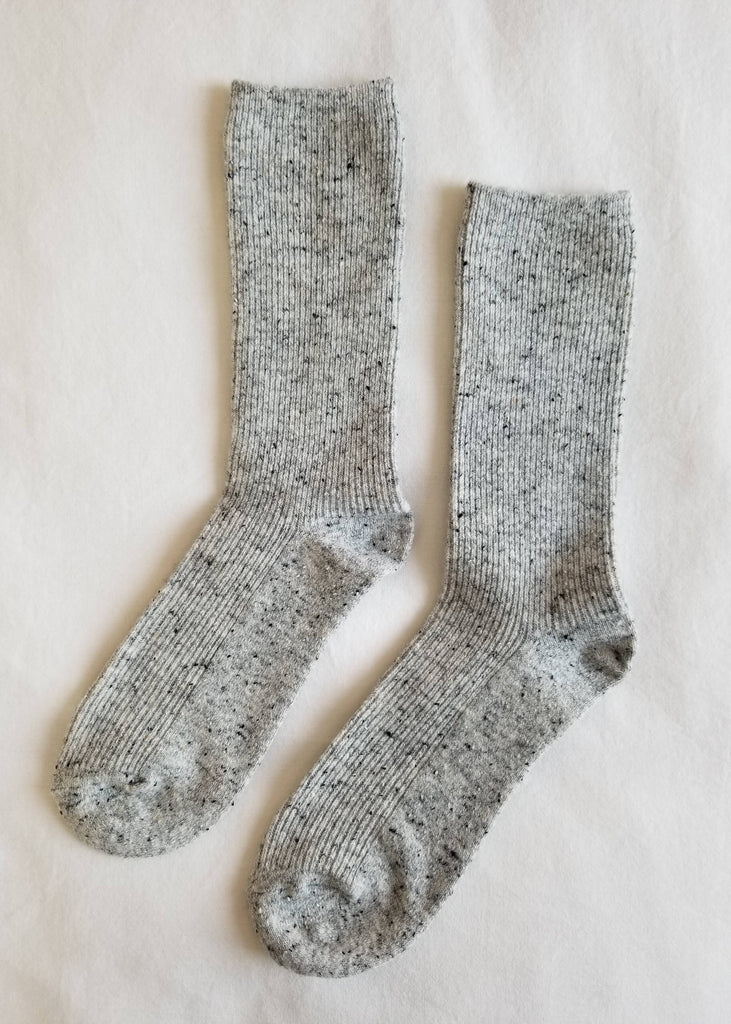 Pair of gray socks on a light beige background