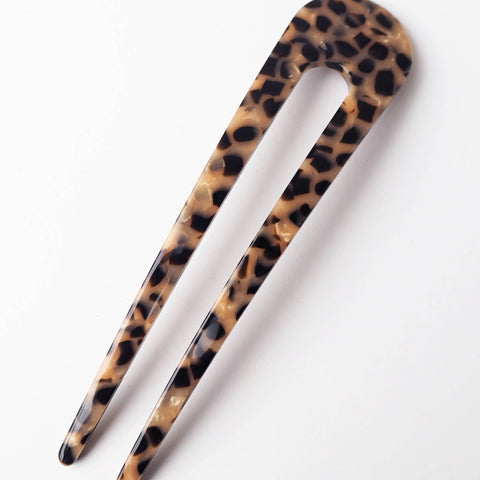 Leopard print hair clip on a white background