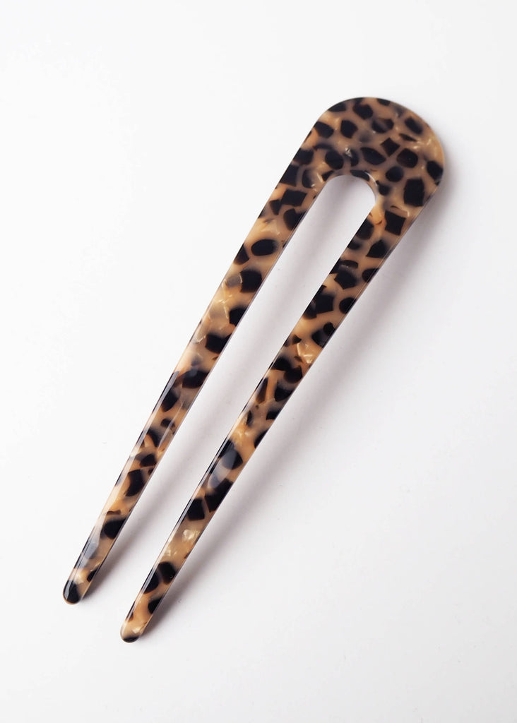 Leopard print hair clip on a white background