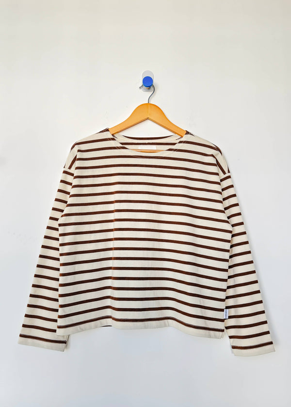 Striped long-sleeve shirt on a hanger against a white background