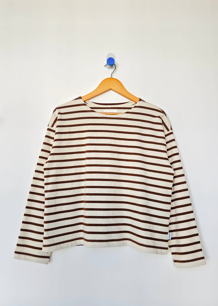 Striped long-sleeve shirt on a hanger against a white background