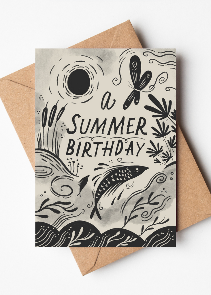 Greeting card with 'A Summer Birthday' text and black illustrations on a beige background, with a brown envelope.