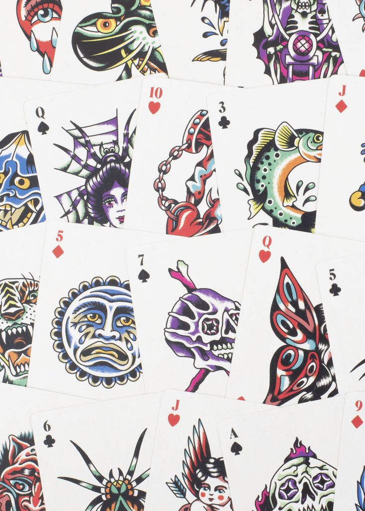 Colorful tattoo-style playing cards with various designs on a white background