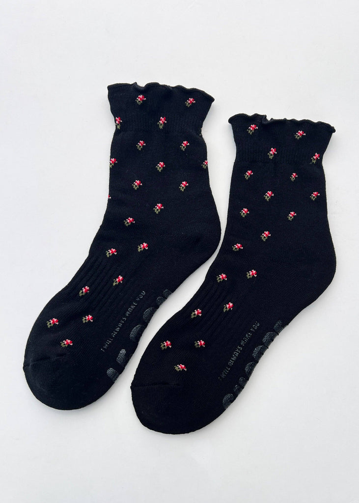 Pair of black socks with pink patterns on a white background