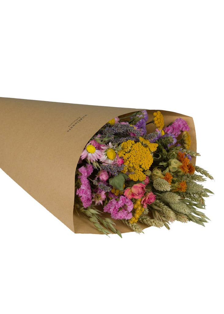 Bouquet of flowers wrapped in brown paper on a white background