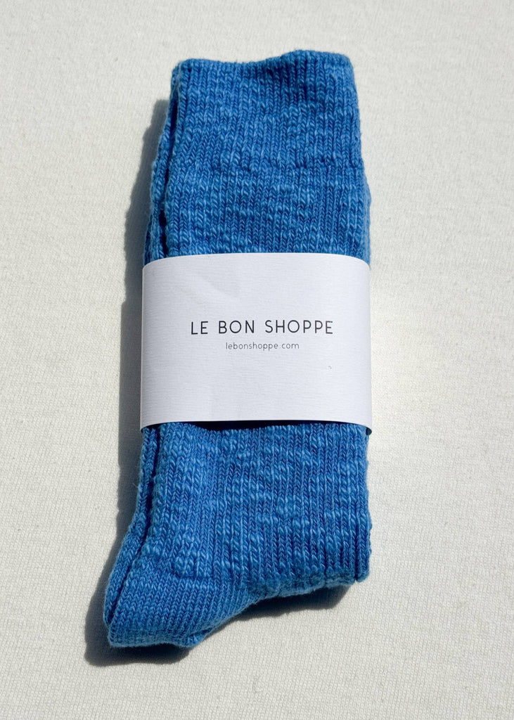 Blue socks with a white label on a light gray background