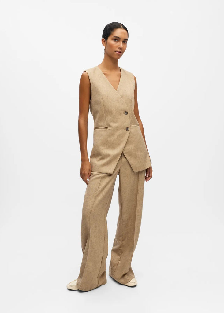Woman wearing a beige suit on a white background