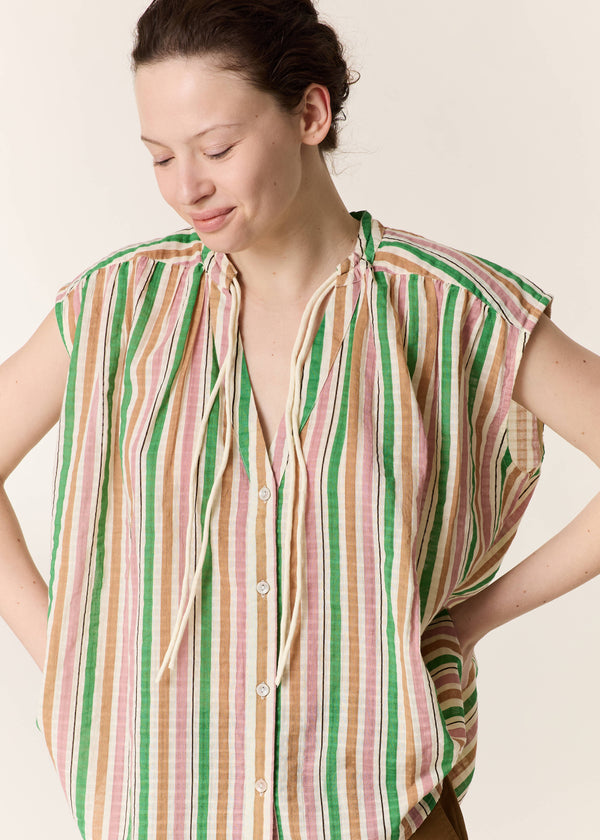 Woman wearing a striped shirt against a plain background