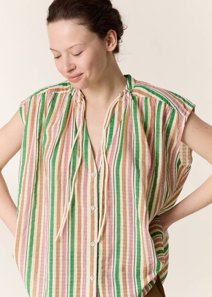 Woman wearing a striped shirt against a plain background