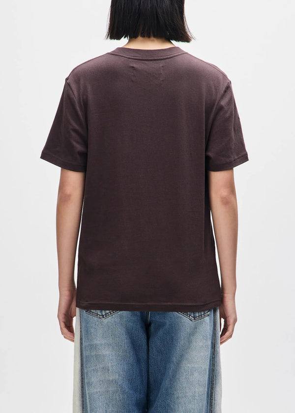 Person wearing a brown t-shirt and blue jeans on a white background