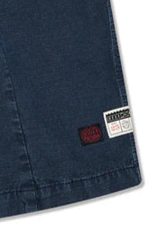 Close-up of a blue fabric with a brand label on a white background