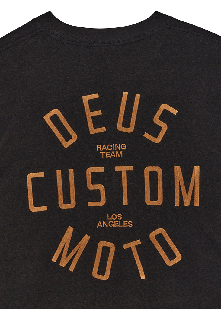 Black t-shirt with 'Deus Custom Moto' text in gold on a white background