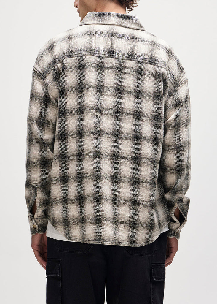 Person wearing a plaid shirt with a white background