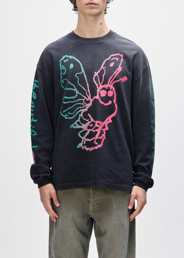 Person wearing a black long-sleeve shirt with colorful lobster design on a white background