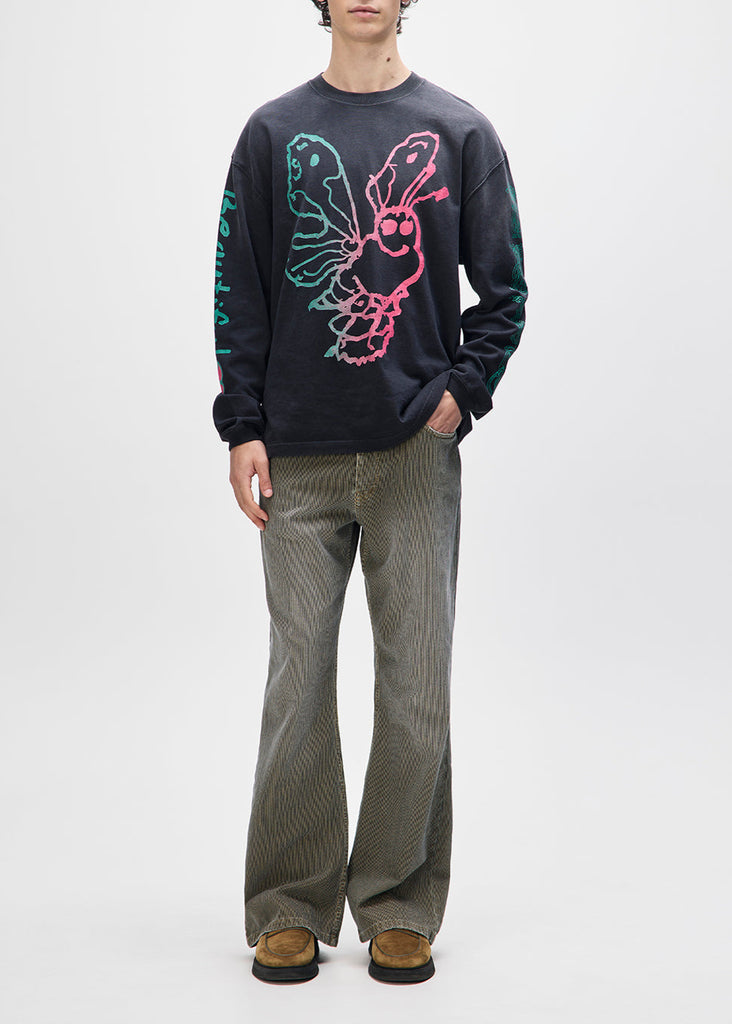 Person wearing a black sweatshirt with a colorful graphic design on a white background