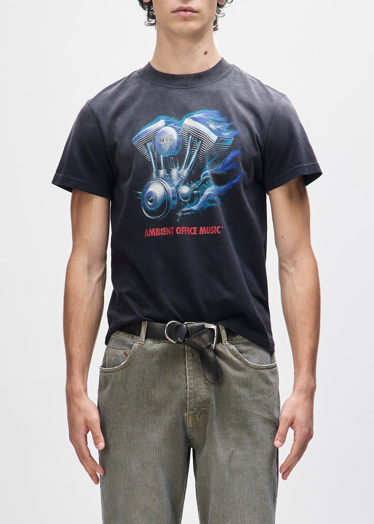 Person wearing a black t-shirt with a graphic design on a plain background