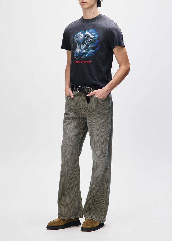 Person wearing a black t-shirt with graphic design and green checkered pants on a white background