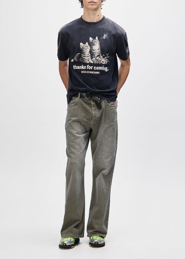 Person wearing a black t-shirt with graphic design and text, standing against a white background
