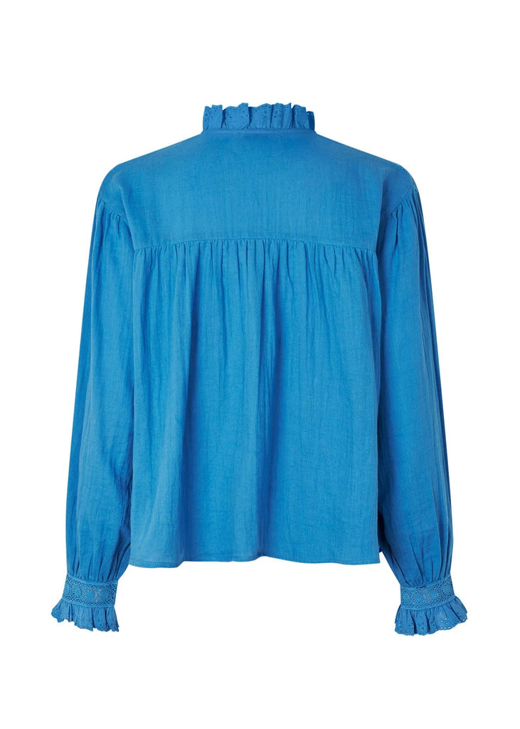 Blue blouse with ruffled collar and cuffs on a white background