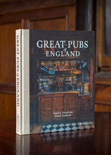 Book titled 'Great Pubs of England' on a wooden surface with a blurred background