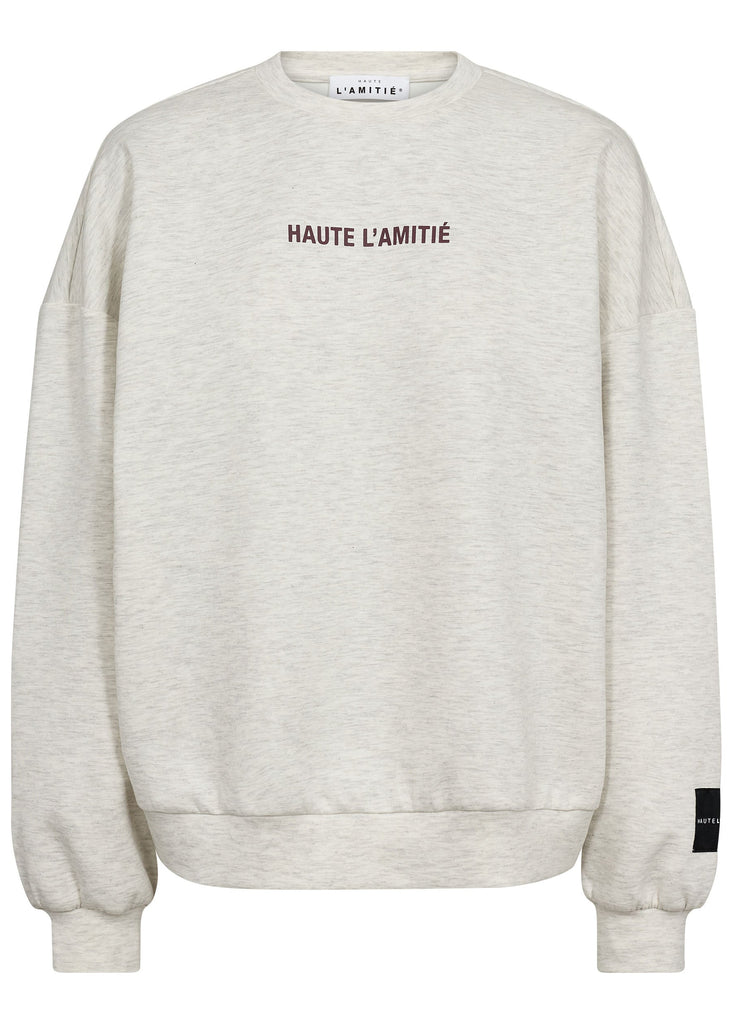 Beige sweatshirt with 'HAUTE L'AMITIE' text on a white background