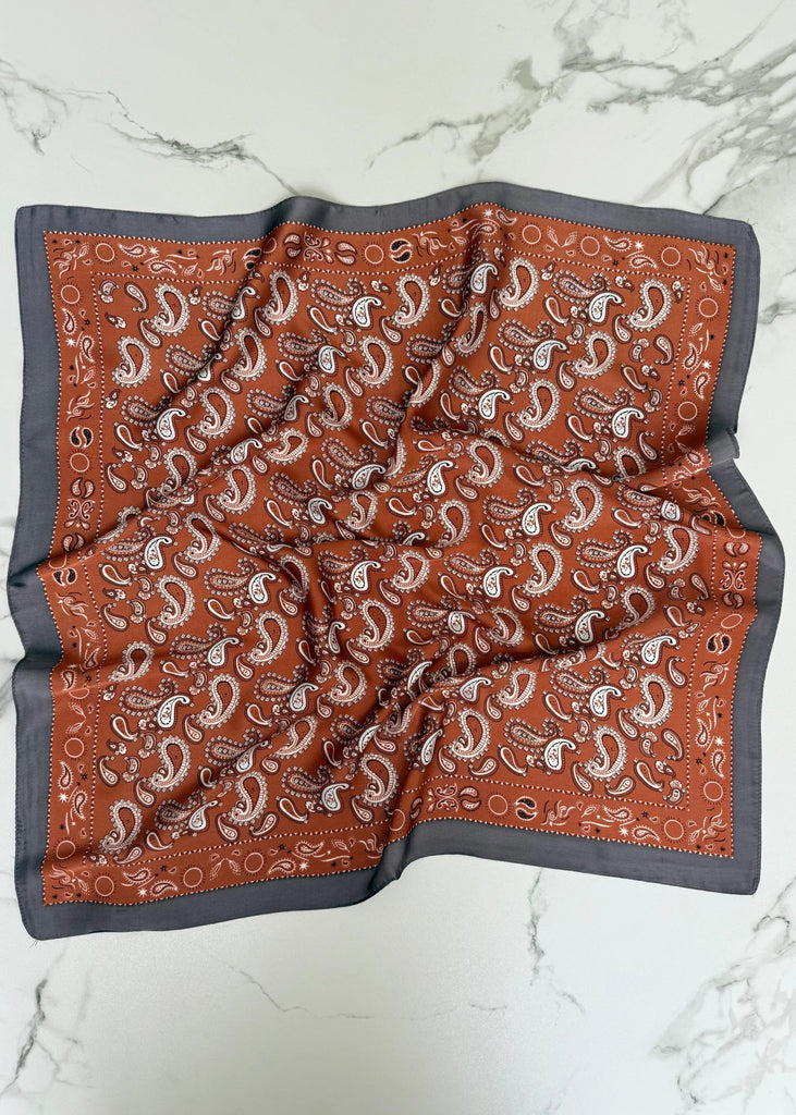Brown paisley patterned fabric on a marble background