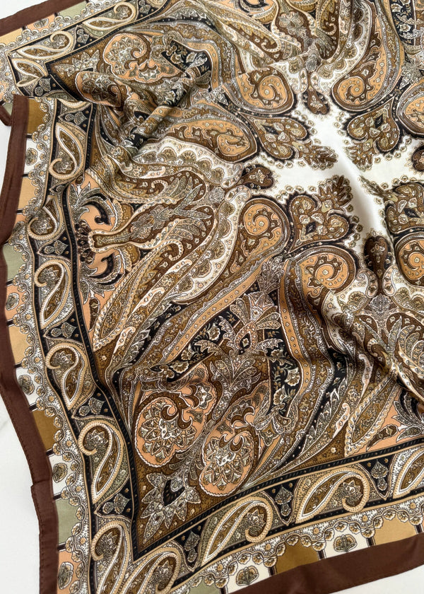 Close-up of a patterned fabric with intricate designs on a white background
