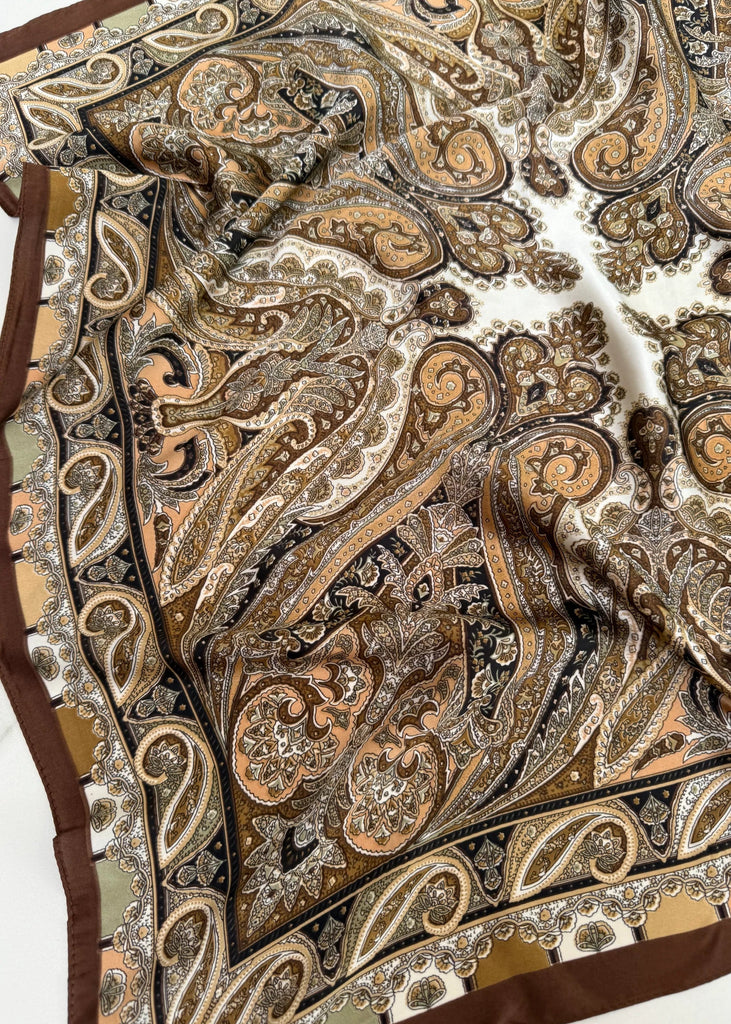 Close-up of a patterned fabric with intricate designs on a white background