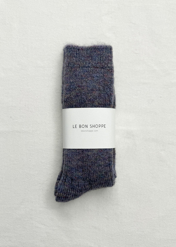 Pair of gray socks with a white label on a light gray background
