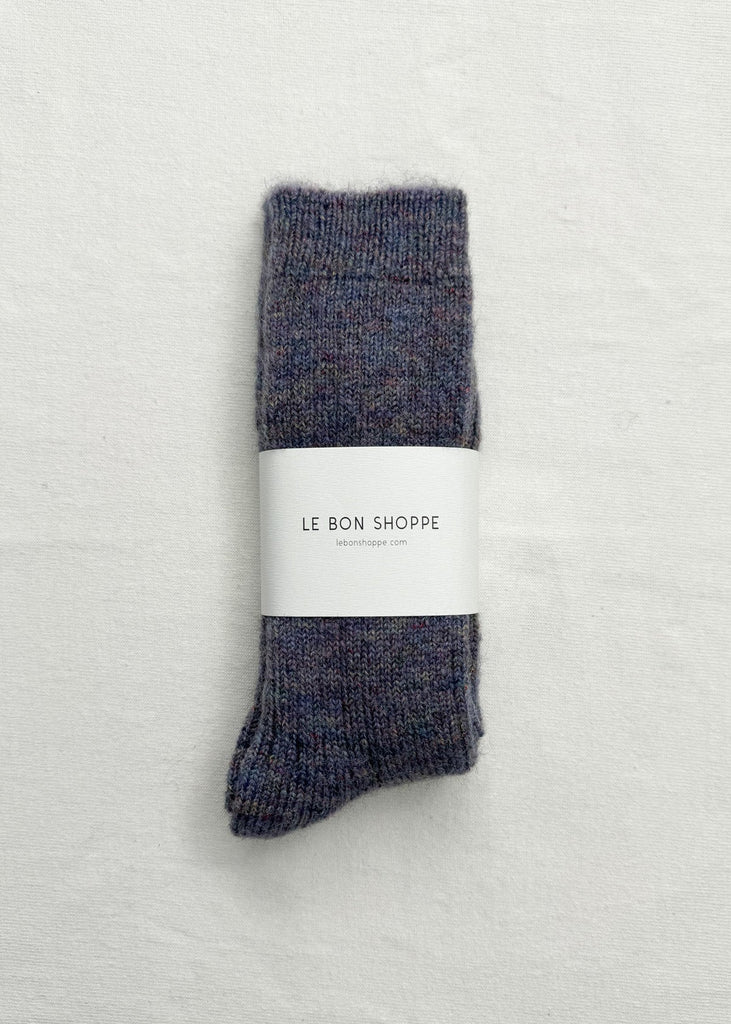 Pair of gray socks with a white label on a light gray background