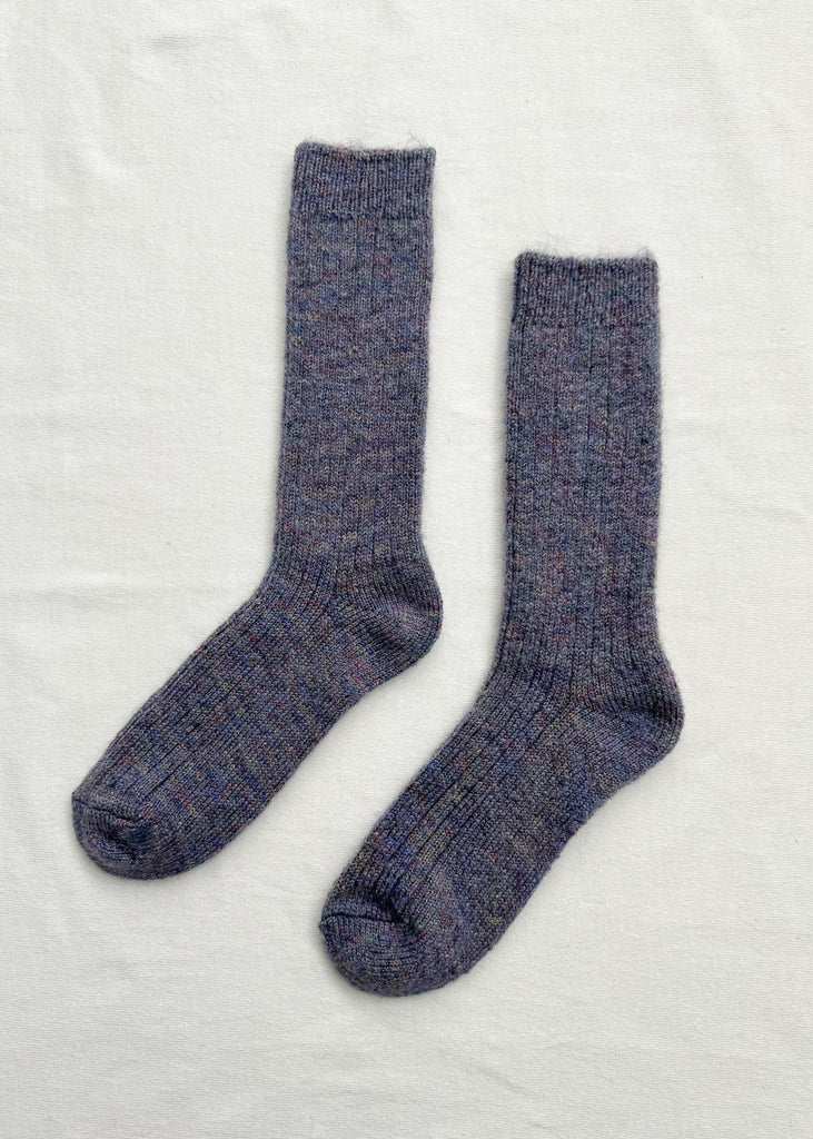 Pair of blue socks on a light gray background