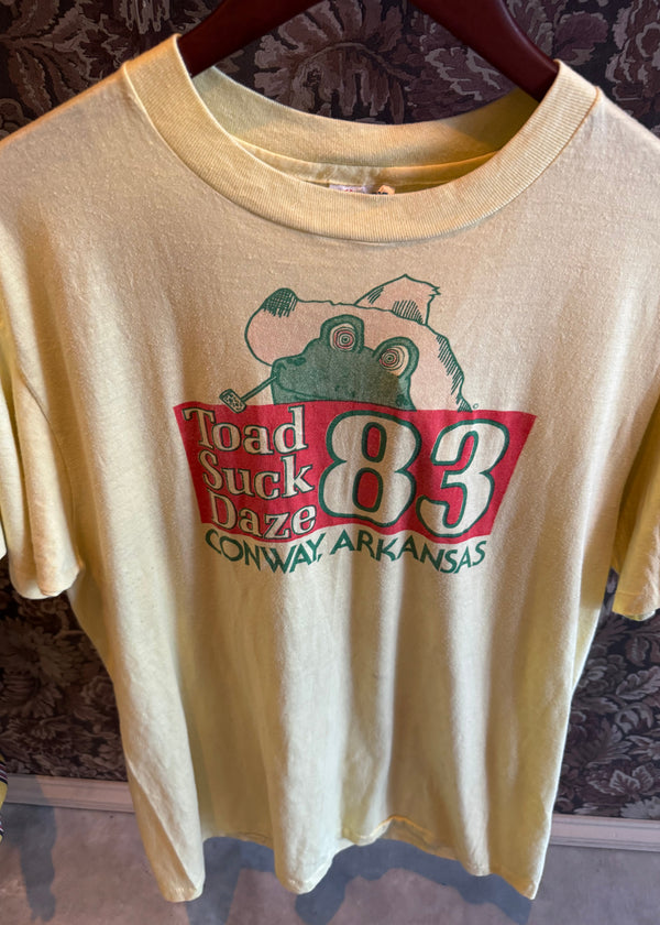 Beige tank top with a graphic design on a patterned background
