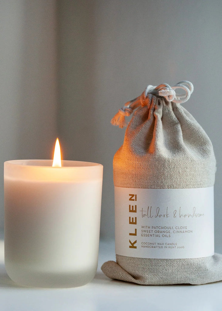 Candle and its packaging on a neutral background
