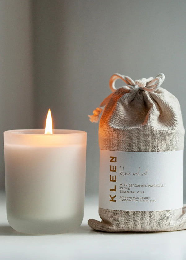 Candle and its packaging labeled 'Kleen' on a neutral background