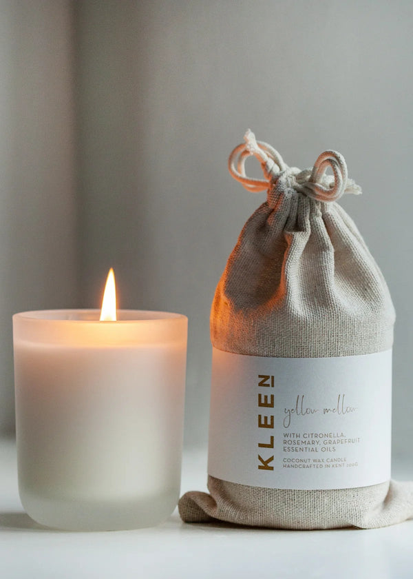 Candle and a drawstring bag labeled 'Kleen' on a neutral background
