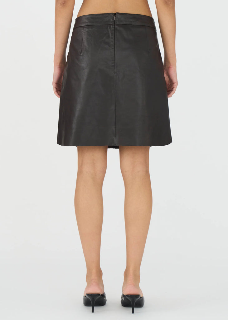 Black skirt worn by a person on a white background