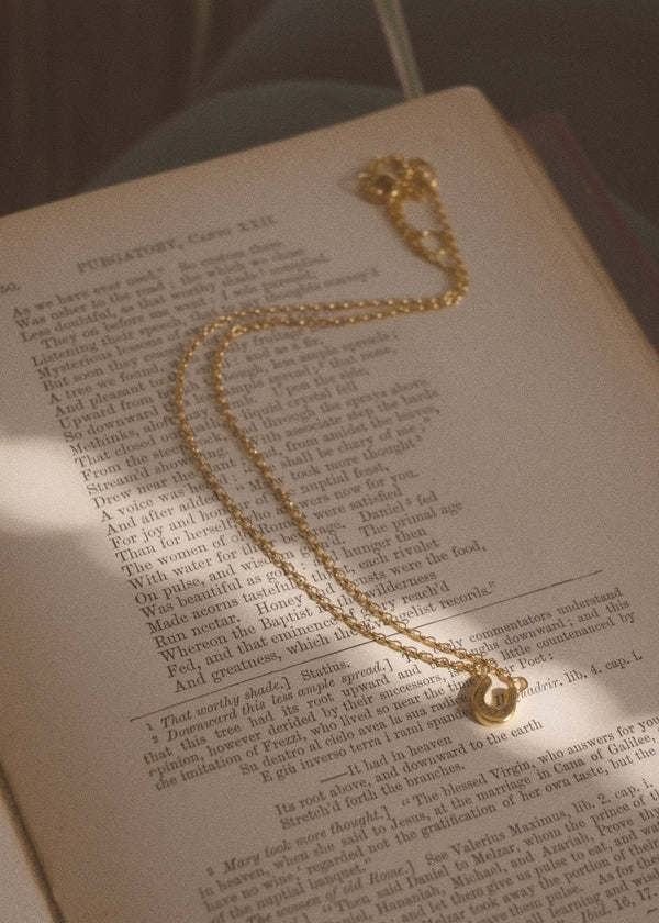 Gold necklace on an open book
