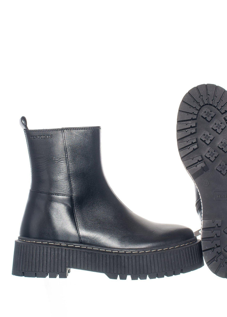 Black leather boot with sole showing on a white background