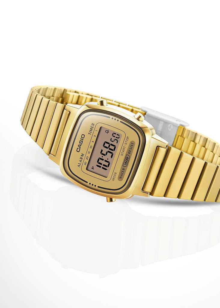 Gold Casio digital watch on a white background
