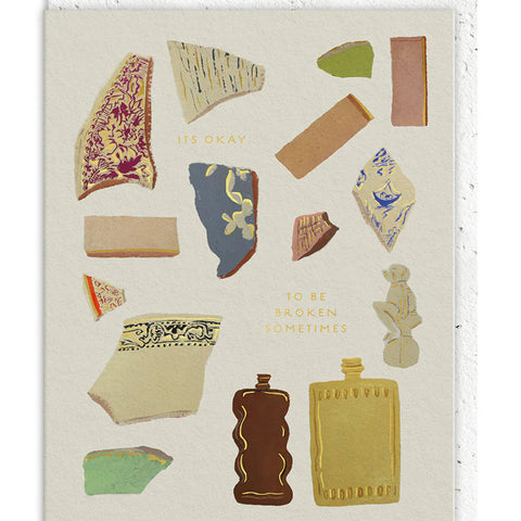 Card with decorative elements resembling ancient pottery shards on a white background