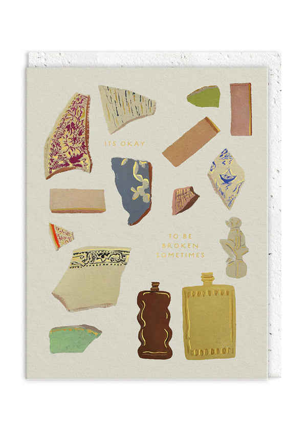 Card with decorative elements resembling ancient pottery shards on a white background