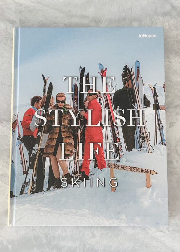 Book cover titled 'The Stylish Life of Skiing' with people holding skis in a snowy setting.