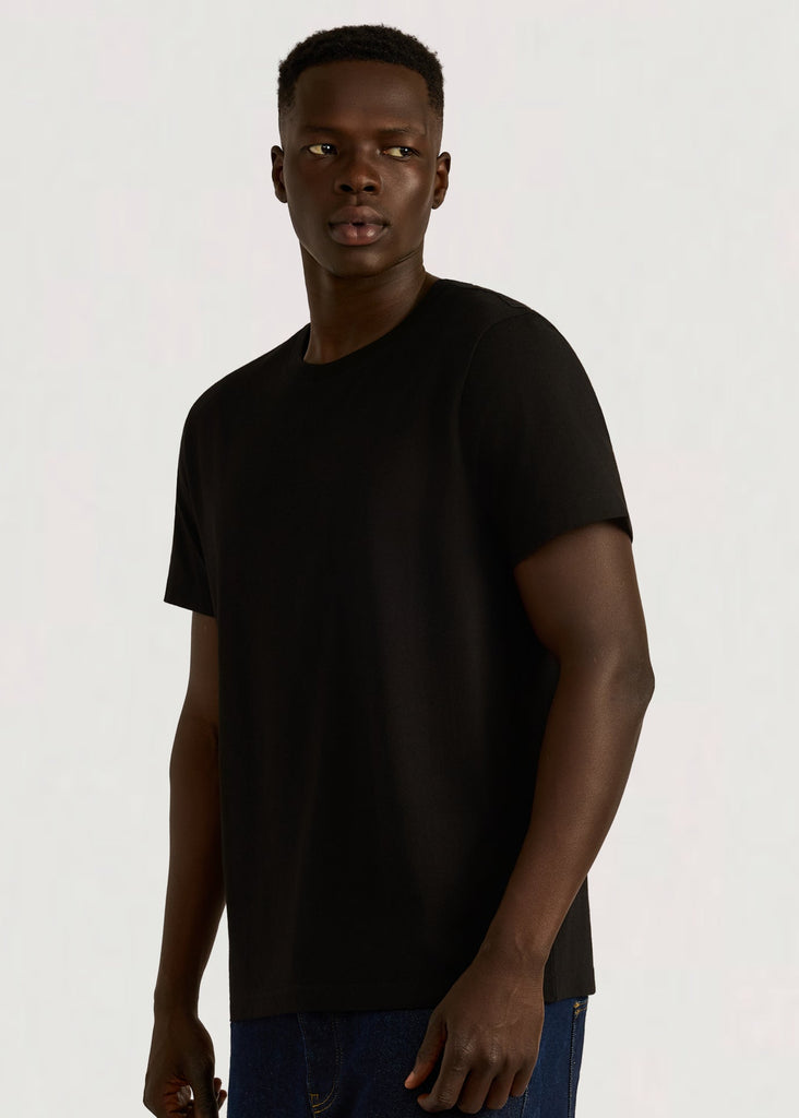 Man wearing a black t-shirt against a white background