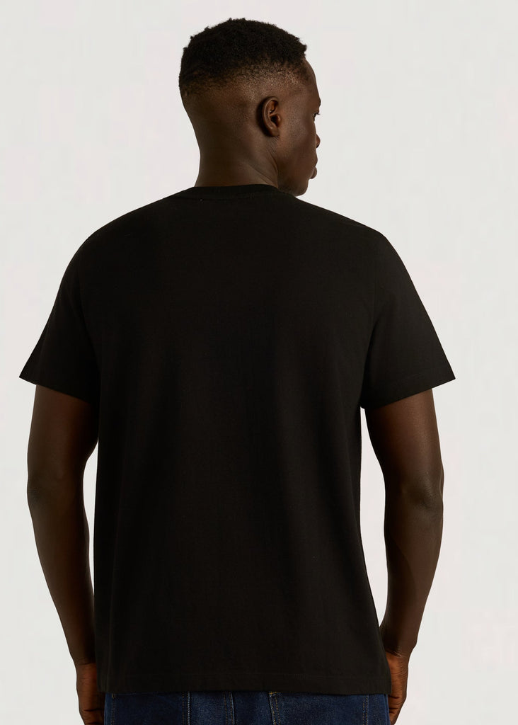 Person wearing a black t-shirt on a plain background