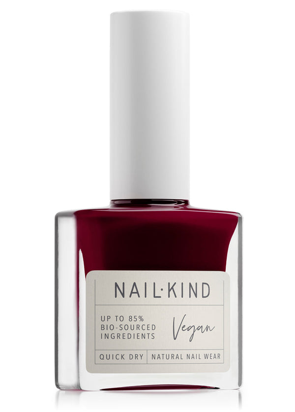 Nail polish bottle with a white cap and red polish on a white background