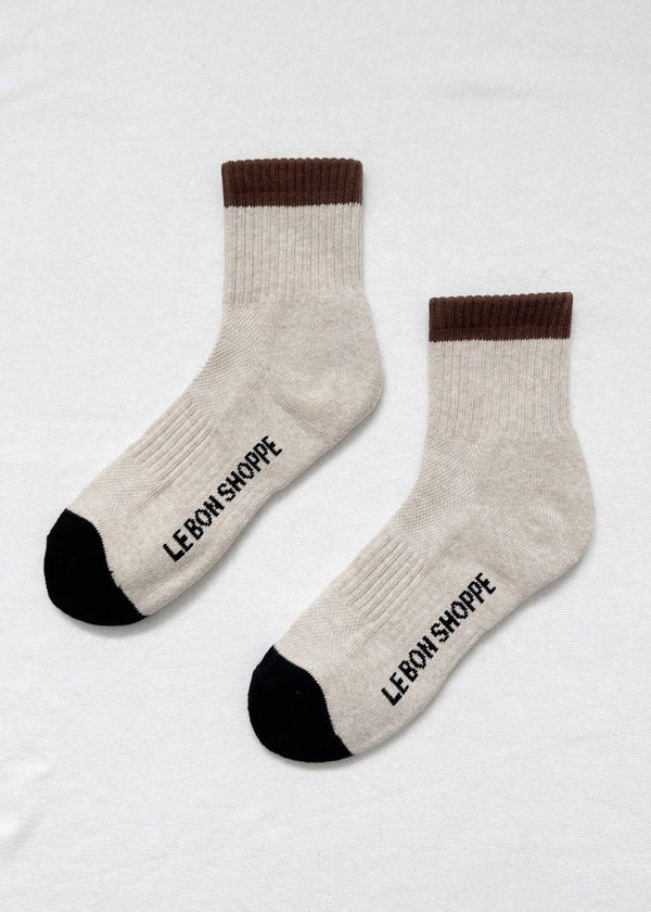 Pair of socks with brown cuffs and black toes on a white background