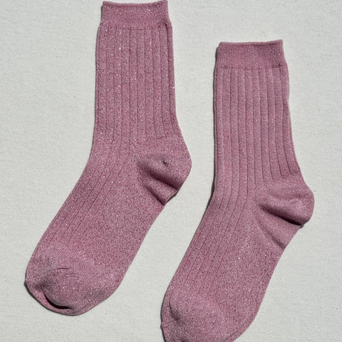 Pair of pink socks on a light gray background